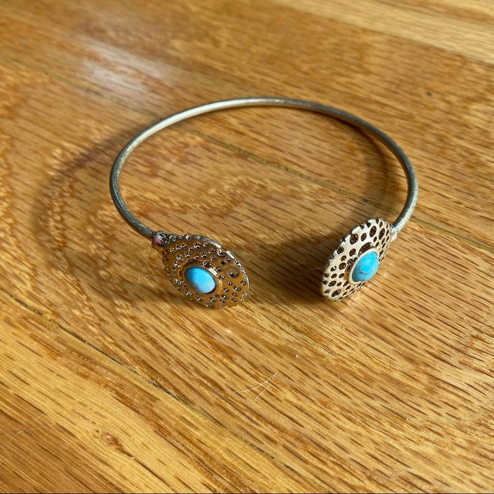 Silver color and turquoise color bracelet.